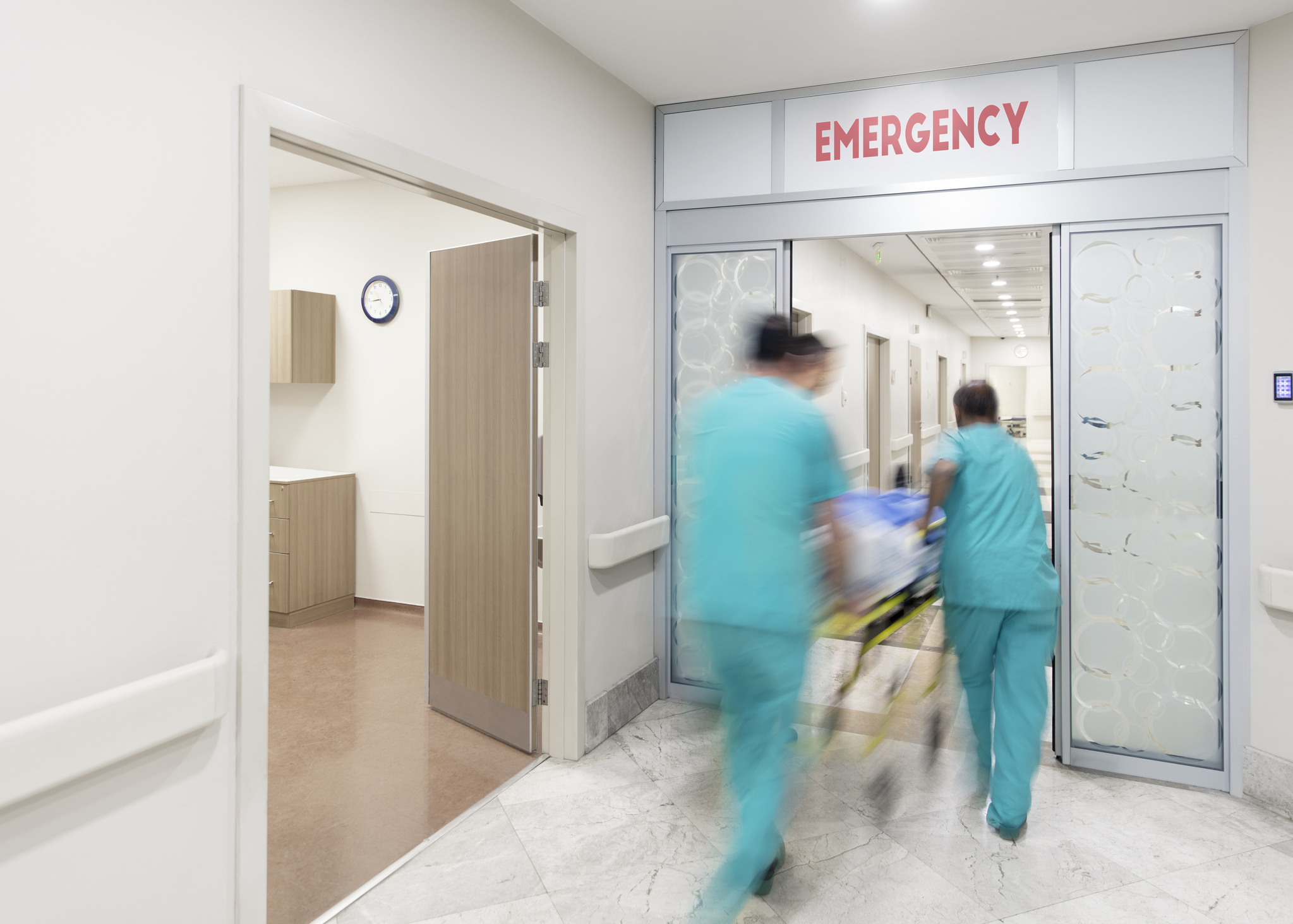 Doctor wheeling patient