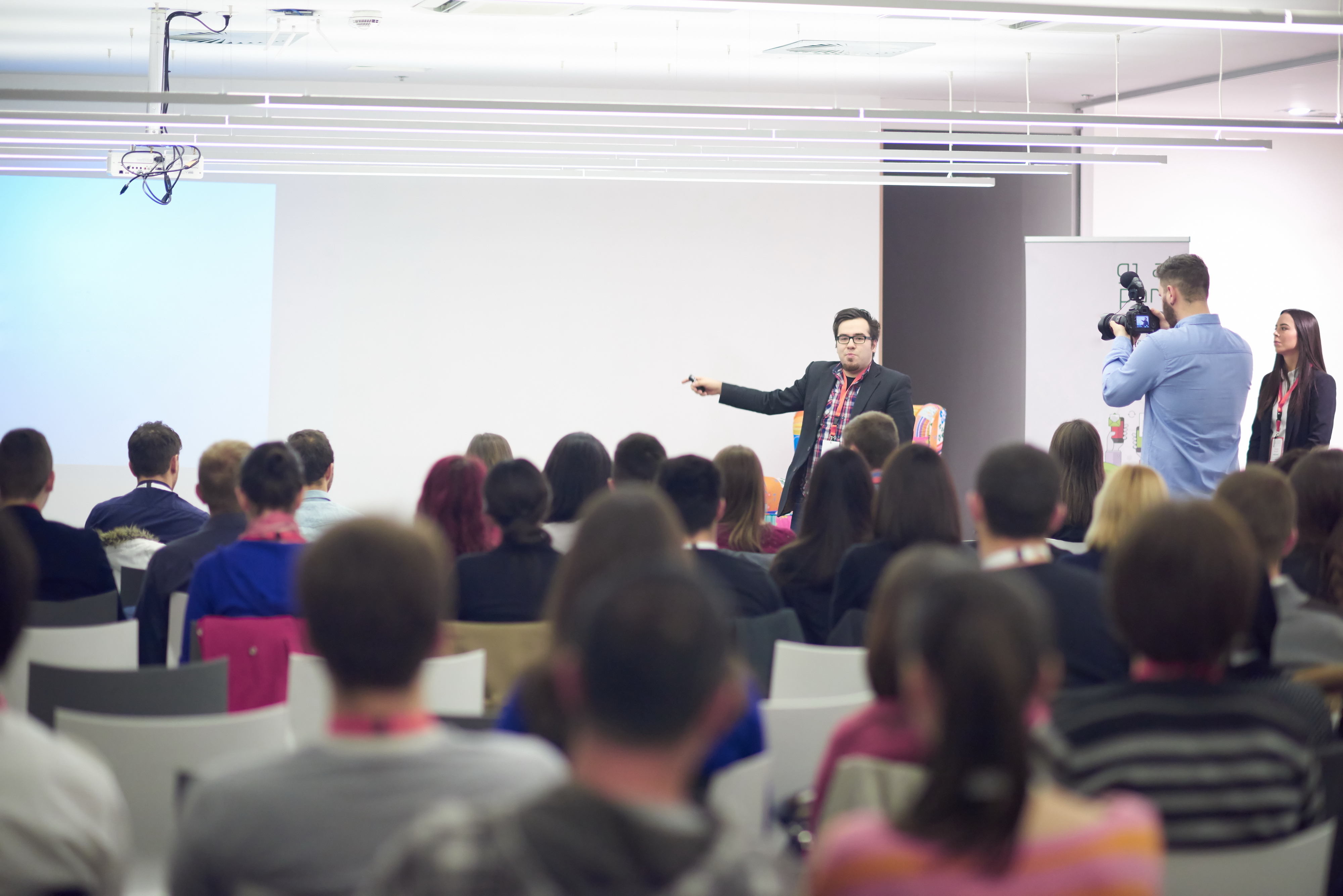speaker on education conference presentation at modern startup interior